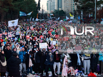 Citizens cheer after the impeachment of President Yoon Suk-yeol is passed in Seoul, South Korea, on December 14, 2024. Approximately 2 milli...