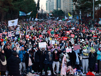 Citizens cheer after the impeachment of President Yoon Suk-yeol is passed in Seoul, South Korea, on December 14, 2024. Approximately 2 milli...