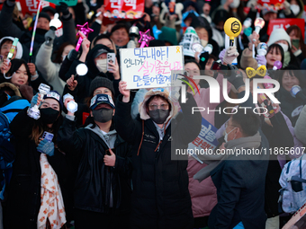 Citizens cheer after the impeachment of President Yoon Suk-yeol is passed in Seoul, South Korea, on December 14, 2024. Approximately 2 milli...