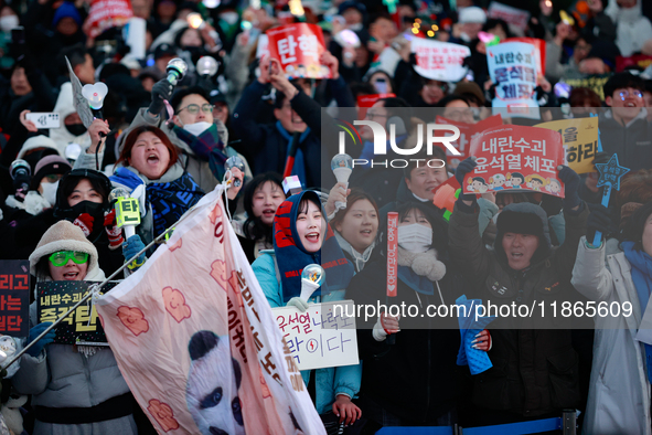 Citizens cheer after the impeachment of President Yoon Suk-yeol is passed in Seoul, South Korea, on December 14, 2024. Approximately 2 milli...