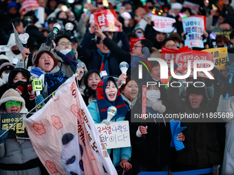 Citizens cheer after the impeachment of President Yoon Suk-yeol is passed in Seoul, South Korea, on December 14, 2024. Approximately 2 milli...