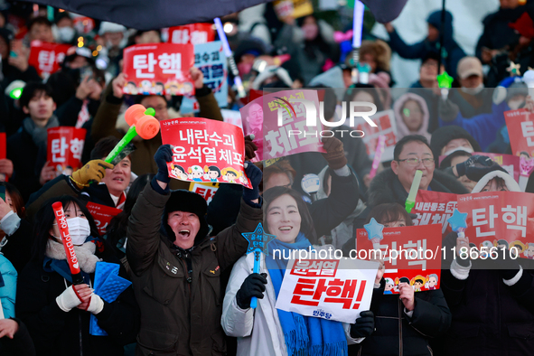 Citizens cheer after the impeachment of President Yoon Suk-yeol is passed in Seoul, South Korea, on December 14, 2024. Approximately 2 milli...