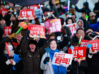 Citizens cheer after the impeachment of President Yoon Suk-yeol is passed in Seoul, South Korea, on December 14, 2024. Approximately 2 milli...