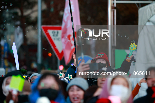 Citizens cheer after the impeachment of President Yoon Suk-yeol is passed in Seoul, South Korea, on December 14, 2024. Approximately 2 milli...