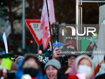 Citizens cheer after the impeachment of President Yoon Suk-yeol is passed in Seoul, South Korea, on December 14, 2024. Approximately 2 milli...