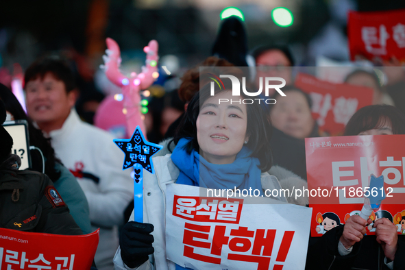 Citizens cheer after the impeachment of President Yoon Suk-yeol is passed in Seoul, South Korea, on December 14, 2024. Approximately 2 milli...