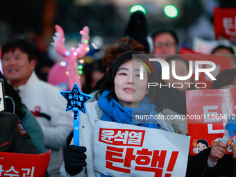 Citizens cheer after the impeachment of President Yoon Suk-yeol is passed in Seoul, South Korea, on December 14, 2024. Approximately 2 milli...