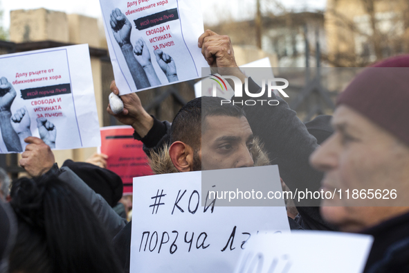 Representatives of the parliamentary party We Continue the Change stand in front of the Sofia City Court in Sofia, Bulgaria, on December 14,...