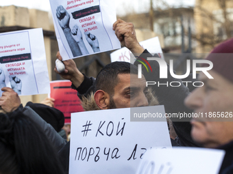 Representatives of the parliamentary party We Continue the Change stand in front of the Sofia City Court in Sofia, Bulgaria, on December 14,...