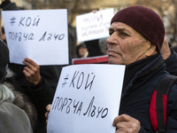 Representatives of the parliamentary party We Continue the Change stand in front of the Sofia City Court in Sofia, Bulgaria, on December 14,...