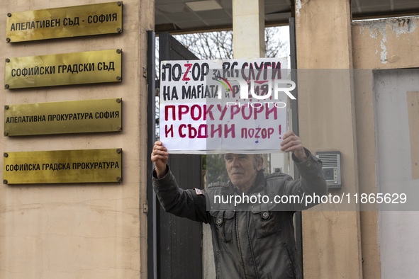 Representatives of the parliamentary party We Continue the Change stand in front of the Sofia City Court in Sofia, Bulgaria, on December 14,...