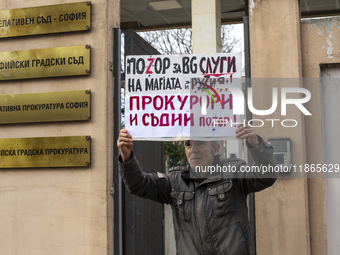 Representatives of the parliamentary party We Continue the Change stand in front of the Sofia City Court in Sofia, Bulgaria, on December 14,...