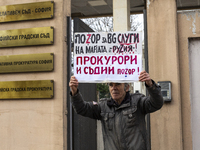 Representatives of the parliamentary party We Continue the Change stand in front of the Sofia City Court in Sofia, Bulgaria, on December 14,...