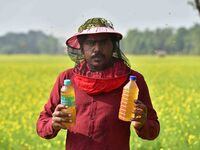 A beekeeper shows raw honey at a honeybee farm near a mustard field in Morigaon district, Assam, India, on December 9, 2024. (