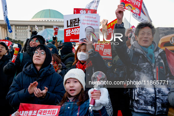 Citizens cheer after the impeachment of President Yoon Suk-yeol is passed in Seoul, South Korea, on December 14, 2024. Approximately 2 milli...