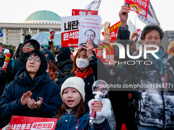 Citizens cheer after the impeachment of President Yoon Suk-yeol is passed in Seoul, South Korea, on December 14, 2024. Approximately 2 milli...