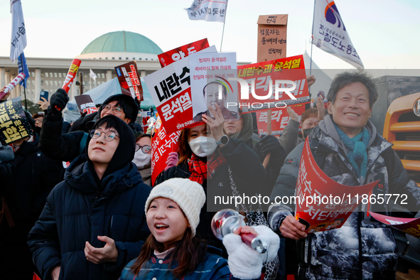 Citizens cheer after the impeachment of President Yoon Suk-yeol is passed in Seoul, South Korea, on December 14, 2024. Approximately 2 milli...