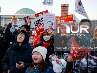 Citizens cheer after the impeachment of President Yoon Suk-yeol is passed in Seoul, South Korea, on December 14, 2024. Approximately 2 milli...