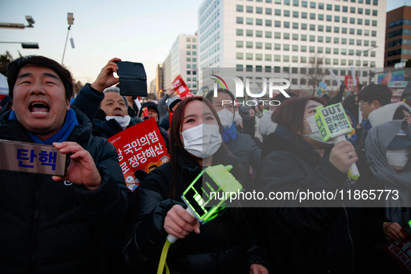 Citizens cheer after the impeachment of President Yoon Suk-yeol is passed in Seoul, South Korea, on December 14, 2024. Approximately 2 milli...