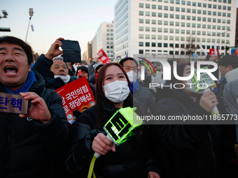 Citizens cheer after the impeachment of President Yoon Suk-yeol is passed in Seoul, South Korea, on December 14, 2024. Approximately 2 milli...