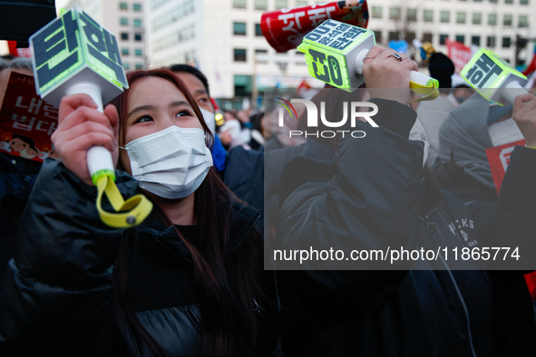 Citizens cheer after the impeachment of President Yoon Suk-yeol is passed in Seoul, South Korea, on December 14, 2024. Approximately 2 milli...