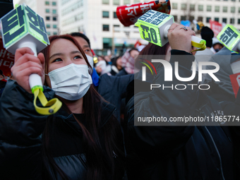 Citizens cheer after the impeachment of President Yoon Suk-yeol is passed in Seoul, South Korea, on December 14, 2024. Approximately 2 milli...