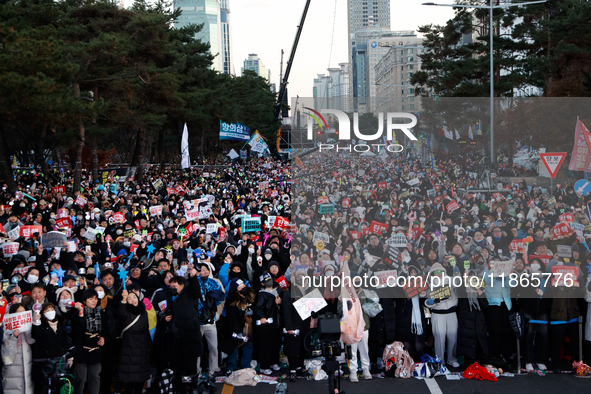 Citizens cheer after the impeachment of President Yoon Suk-yeol is passed in Seoul, South Korea, on December 14, 2024. Approximately 2 milli...