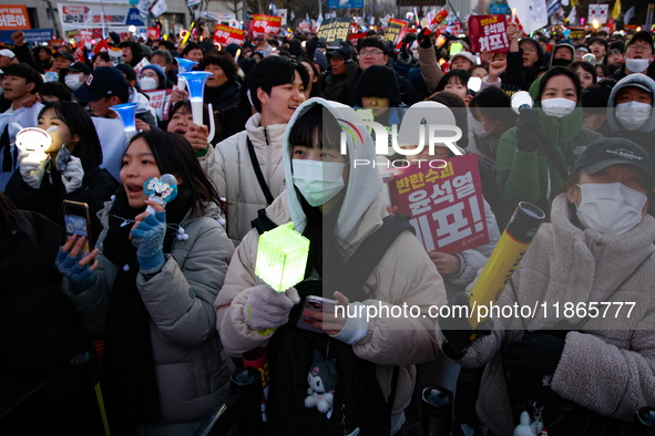 Citizens cheer after the impeachment of President Yoon Suk-yeol is passed in Seoul, South Korea, on December 14, 2024. Approximately 2 milli...