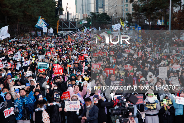 Citizens cheer after the impeachment of President Yoon Suk-yeol is passed in Seoul, South Korea, on December 14, 2024. Approximately 2 milli...