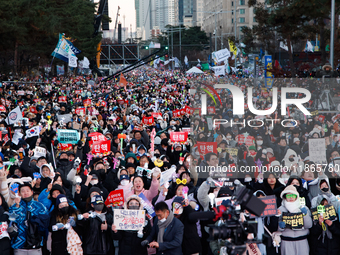 Citizens cheer after the impeachment of President Yoon Suk-yeol is passed in Seoul, South Korea, on December 14, 2024. Approximately 2 milli...