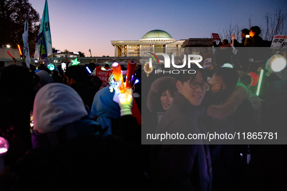 Citizens cheer after the impeachment of President Yoon Suk-yeol is passed in Seoul, South Korea, on December 14, 2024. Approximately 2 milli...