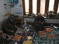 In Srinagar, Kashmir, India, on December 14, 2024, Kashmiri artisans paint Christmas ornaments at the workshop before sending them to the ma...