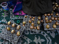 In Srinagar, Kashmir, India, on December 14, 2024, a Kashmiri artisan paints Christmas gift items at the workshop before sending them to the...