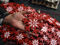 In Srinagar, Kashmir, India, on December 14, 2024, a Kashmiri artisan shows gift items at the workshop before sending them to the market ahe...