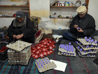 In Srinagar, Kashmir, India, on December 14, 2024, Kashmiri artisan Muhammad Akhtar Mir paints Christmas gift items at his workshop before s...