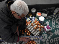 In Srinagar, Kashmir, India, on December 14, 2024, a Kashmiri artisan paints Christmas gift items at the workshop before sending them to the...