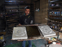 In Srinagar, Kashmir, India, on December 14, 2024, a Kashmiri artisan shows gift items at the workshop before sending them to the market ahe...