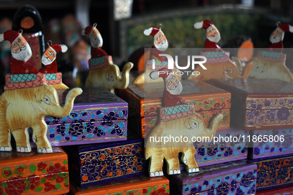 In Srinagar, Kashmir, India, on December 14, 2024, Christmas ornaments of Santa Claus are ready at the workshop before being sent to the mar...