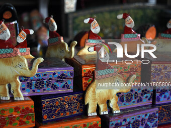 In Srinagar, Kashmir, India, on December 14, 2024, Christmas ornaments of Santa Claus are ready at the workshop before being sent to the mar...