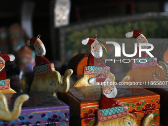 In Srinagar, Kashmir, India, on December 14, 2024, Christmas ornaments of Santa Claus are ready at the workshop before being sent to the mar...