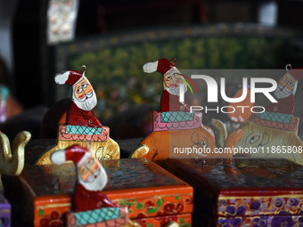 In Srinagar, Kashmir, India, on December 14, 2024, Christmas ornaments of Santa Claus are ready at the workshop before being sent to the mar...