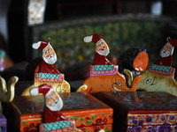 In Srinagar, Kashmir, India, on December 14, 2024, Christmas ornaments of Santa Claus are ready at the workshop before being sent to the mar...