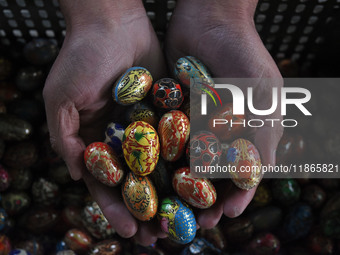 In Srinagar, Kashmir, India, on December 14, 2024, a Kashmiri artisan shows baubles at the workshop before sending them to the market ahead...