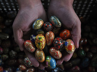 In Srinagar, Kashmir, India, on December 14, 2024, a Kashmiri artisan shows baubles at the workshop before sending them to the market ahead...