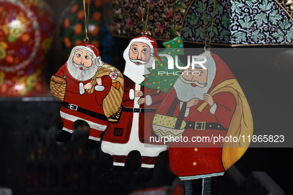 In Srinagar, Kashmir, India, on December 14, 2024, Christmas ornaments of Santa Claus are ready at the workshop before being sent to the mar...