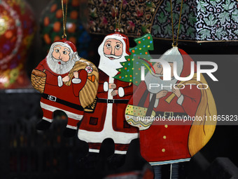 In Srinagar, Kashmir, India, on December 14, 2024, Christmas ornaments of Santa Claus are ready at the workshop before being sent to the mar...