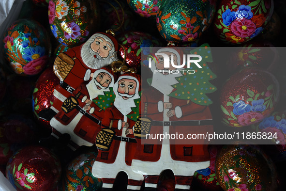 In Srinagar, Kashmir, India, on December 14, 2024, Christmas ornaments of Santa Claus are ready at the workshop before being sent to the mar...