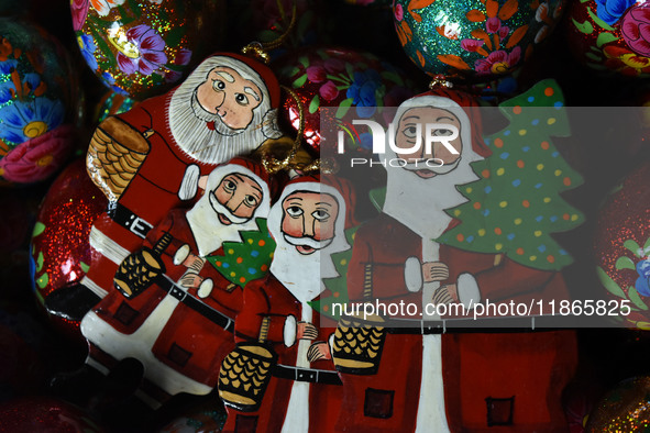 In Srinagar, Kashmir, India, on December 14, 2024, Christmas ornaments of Santa Claus are ready at the workshop before being sent to the mar...