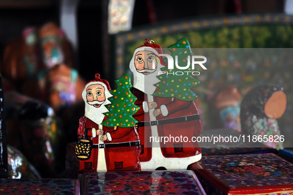 In Srinagar, Kashmir, India, on December 14, 2024, Christmas ornaments of Santa Claus are ready at the workshop before being sent to the mar...