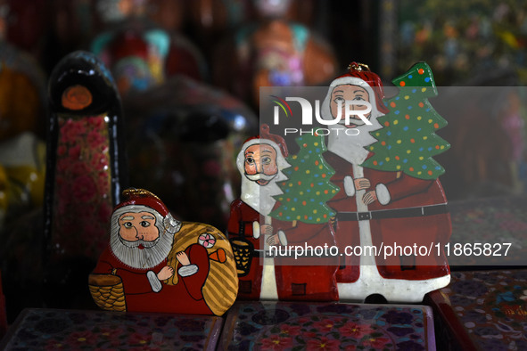 In Srinagar, Kashmir, India, on December 14, 2024, Christmas ornaments of Santa Claus are ready at the workshop before being sent to the mar...